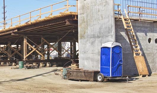 portable toilets stacked at a busy job site